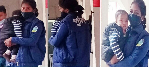 সন্তান কোলে, কাঁধে বন্দুক, দায়িত্ব পালনে পুলিশ সদস্য